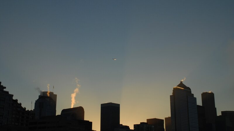 Airplane over City Skyline — Blue, Dramatic