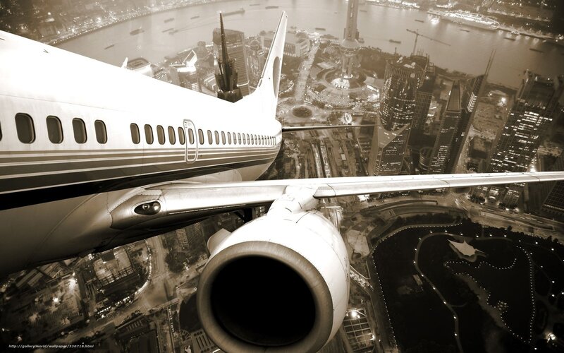 Airplane over city skyline