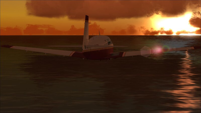 Airplane over ocean at sunset