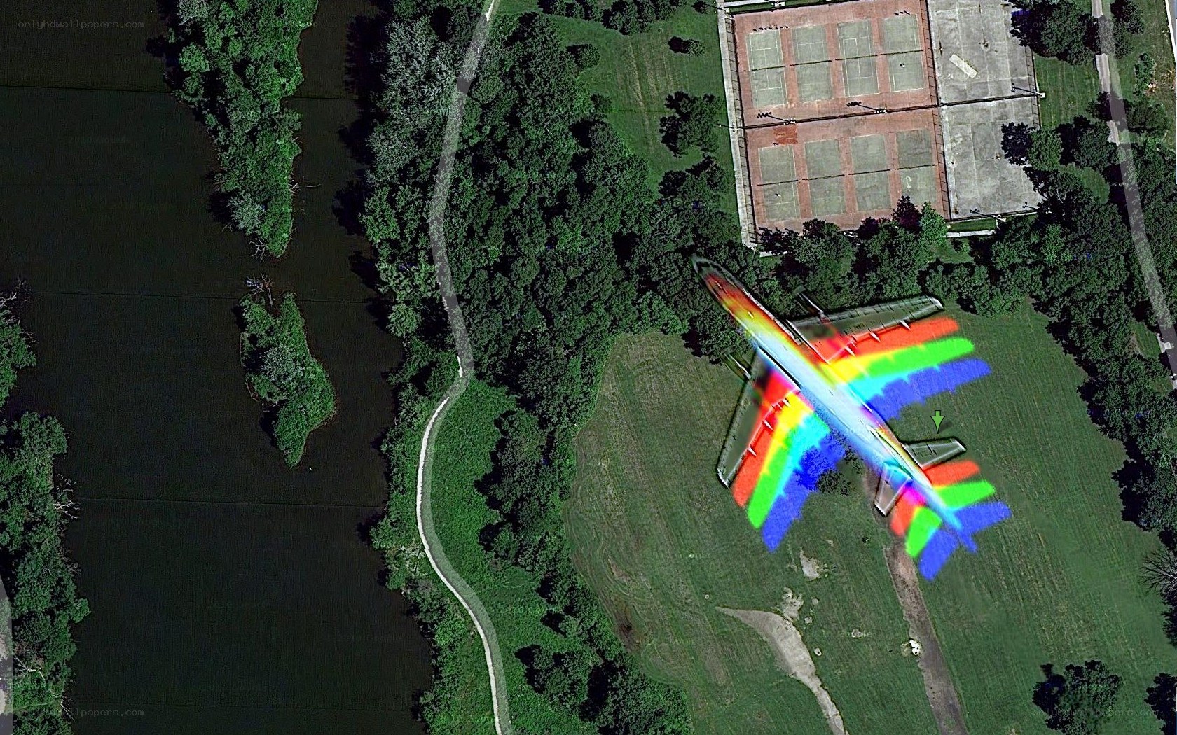 airplane over park and river