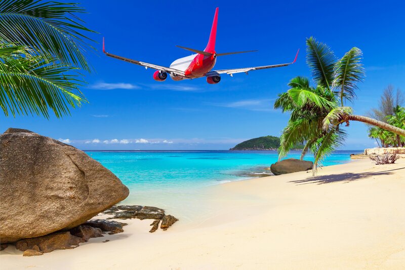 Airplane over Tropical Beach
