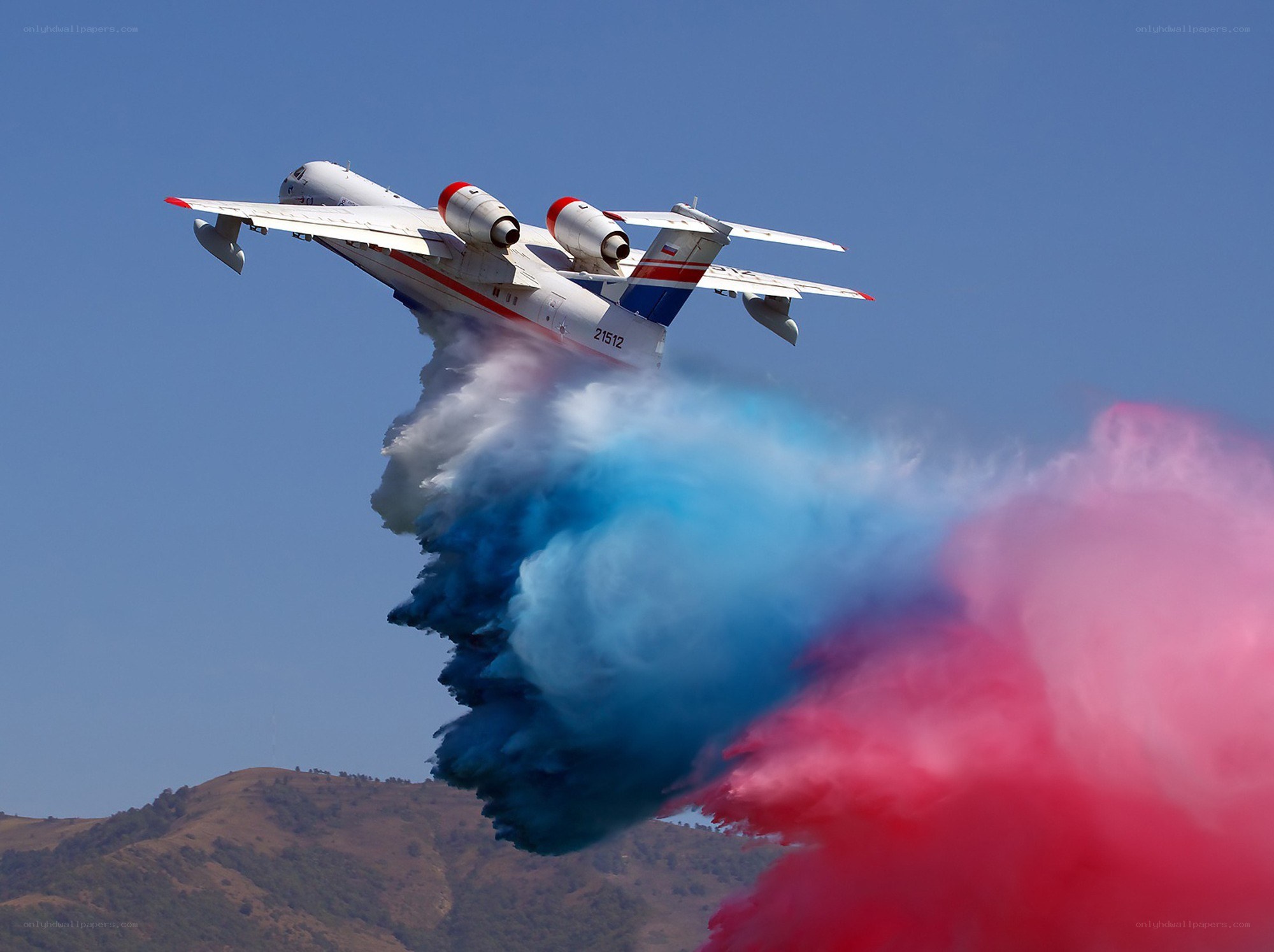 airplane releasing colored smoke