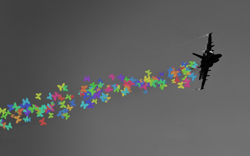 airplane releasing colorful butterflies