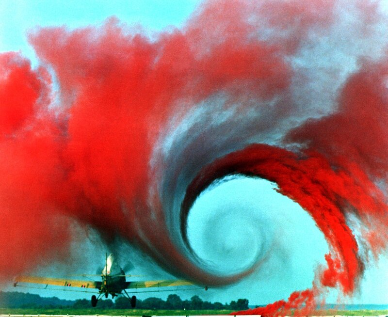 Airplane releasing red smoke