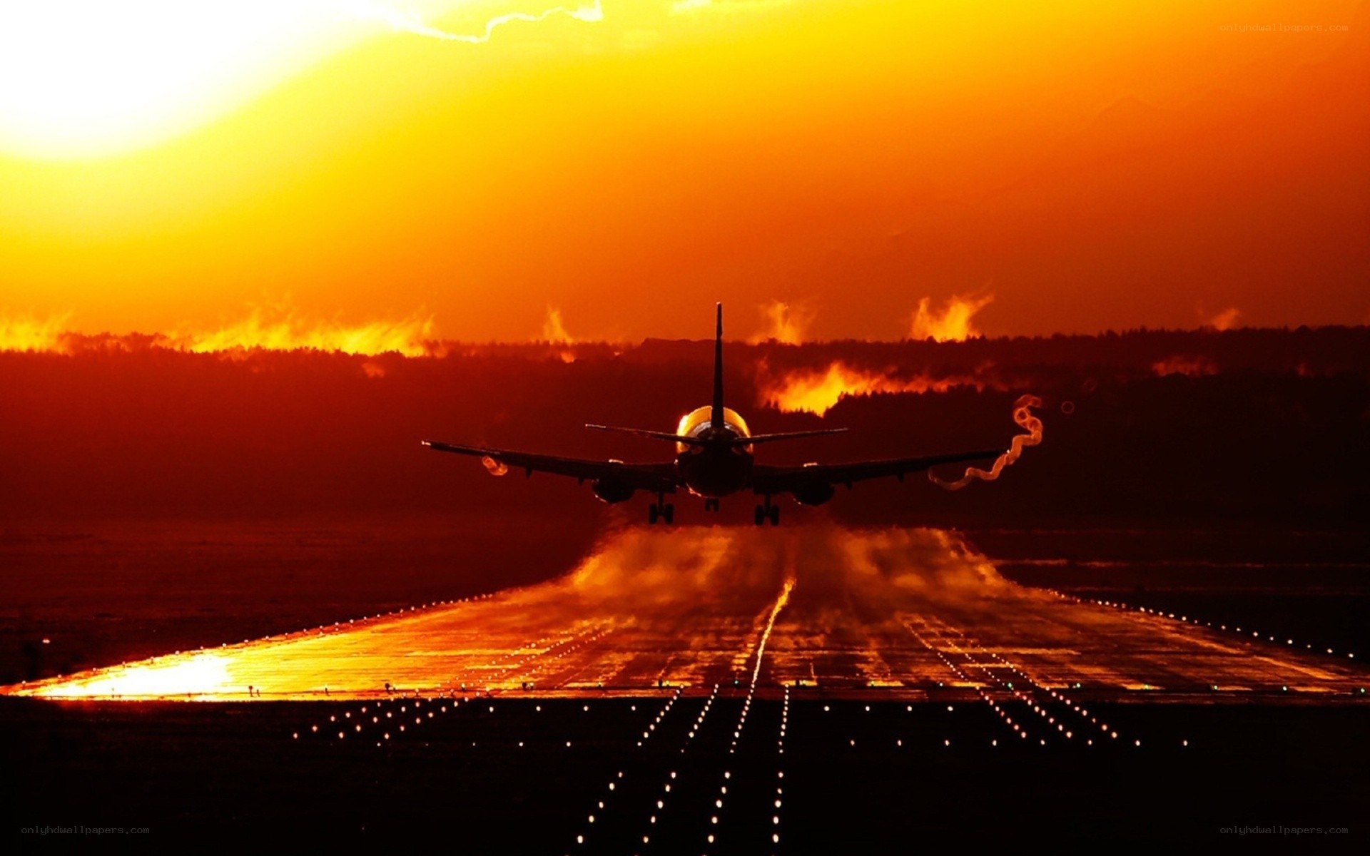 Airplane taking off at sunset