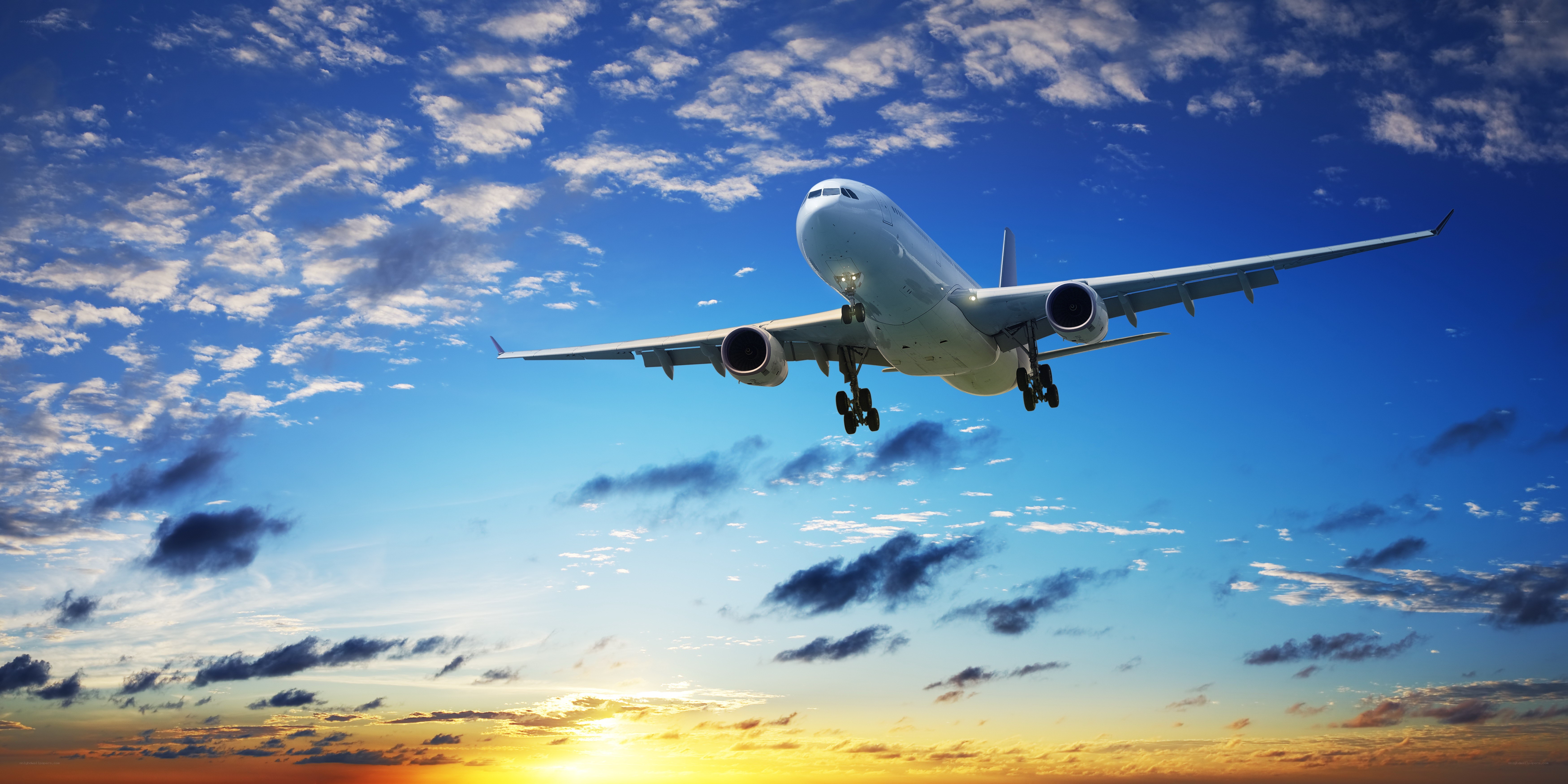 Airplane taking off at sunset