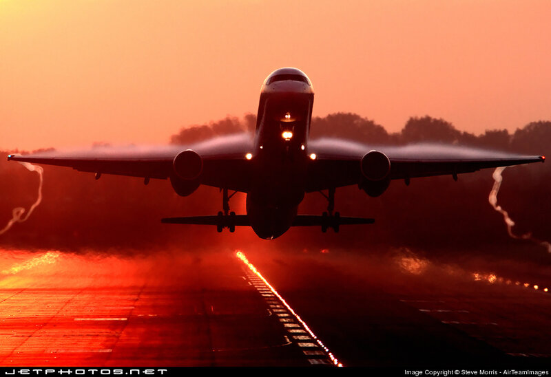 Airplane taking off at sunset