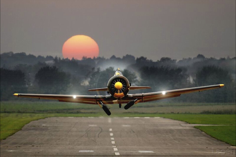 airplane taking off at sunset
