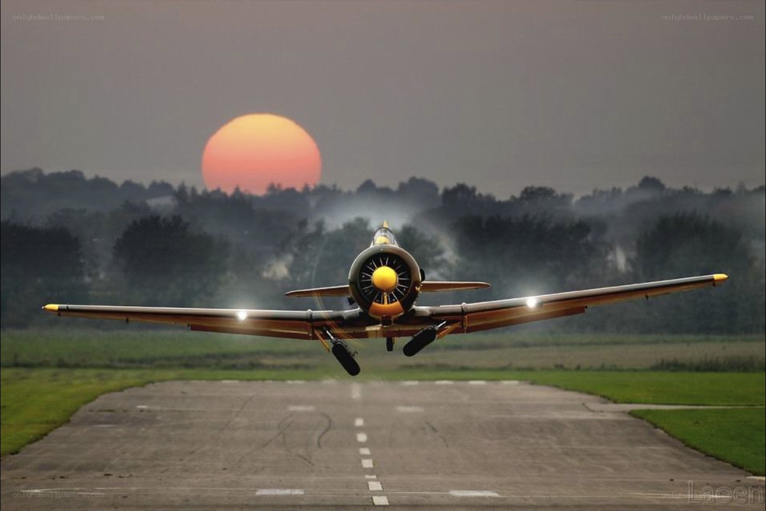 airplane taking off at sunset
