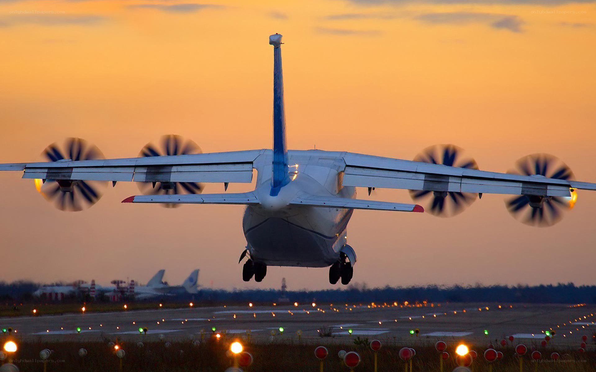 airplane taking off at sunset