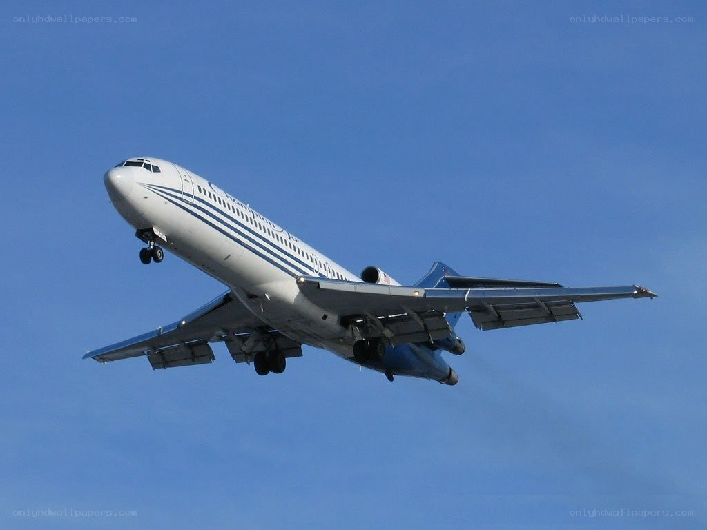 airplane taking off into blue sky