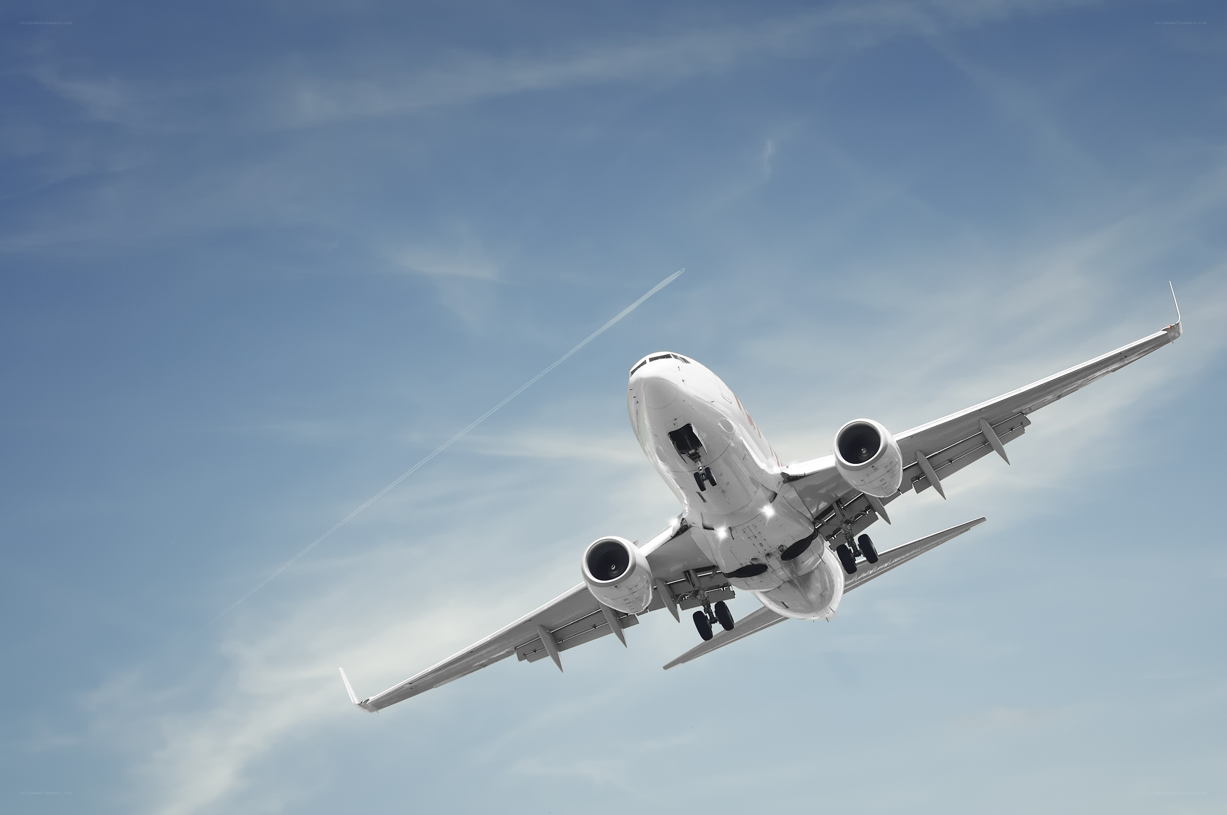 Airplane taking off into blue sky