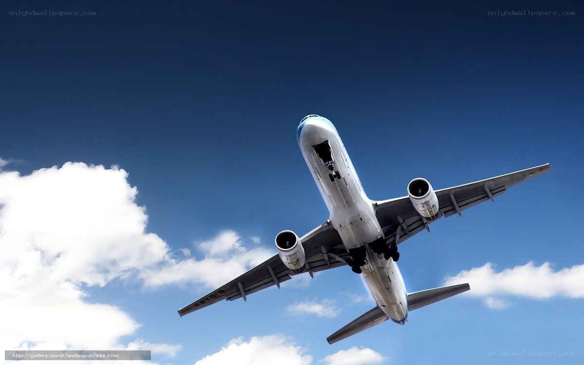 Airplane taking off into blue sky