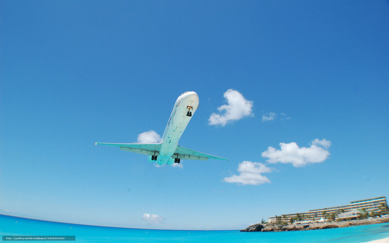 airplane taking off over beach