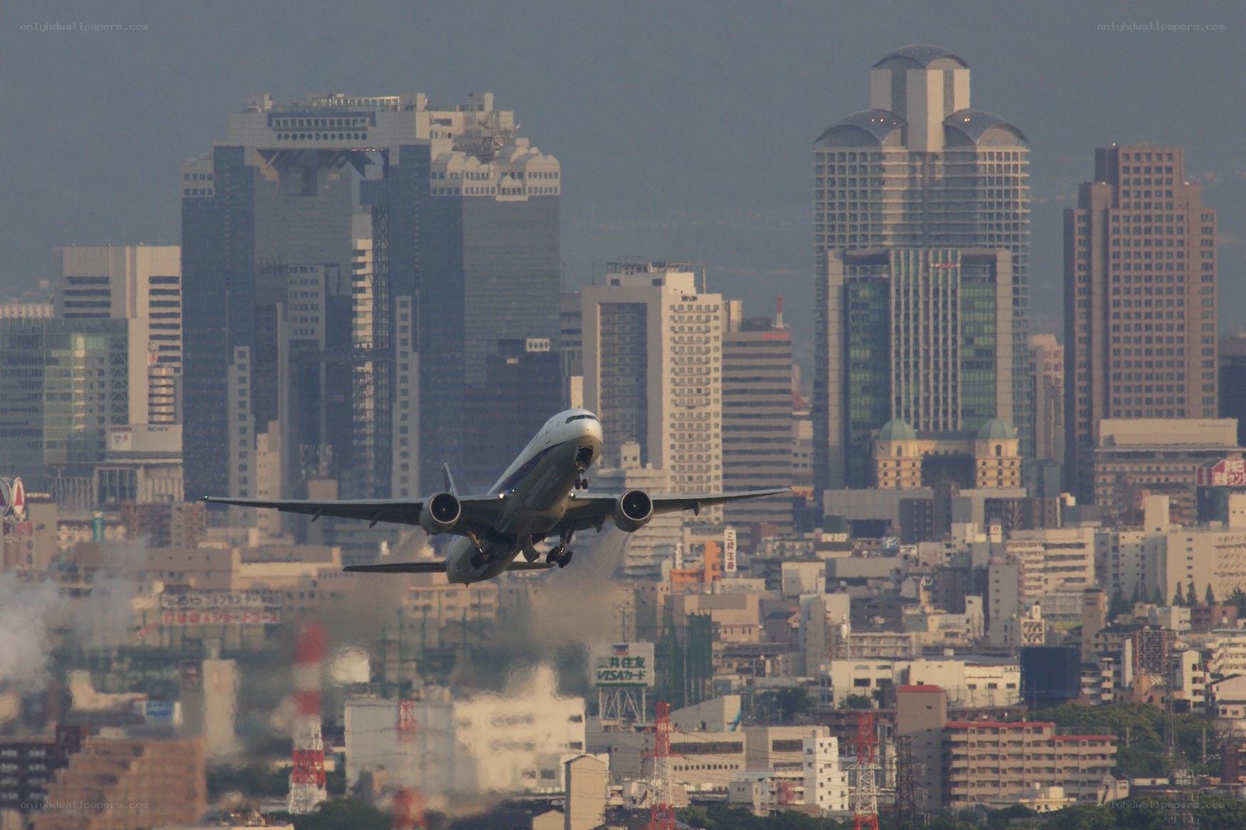 Airplane taking off over city