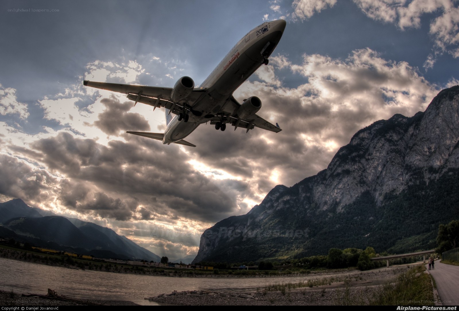 Airplane taking off over mountains