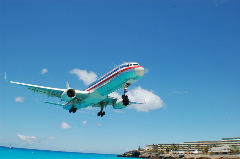 Airplane taking off over ocean