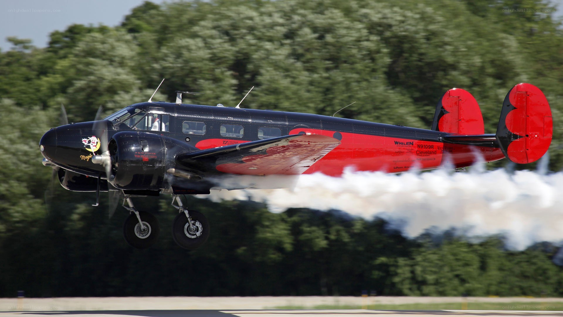 airplane taking off with smoke