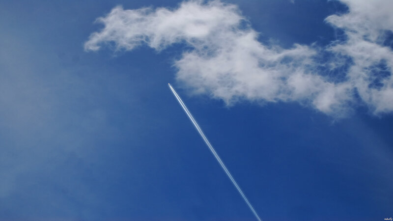 Airplane trail in blue sky