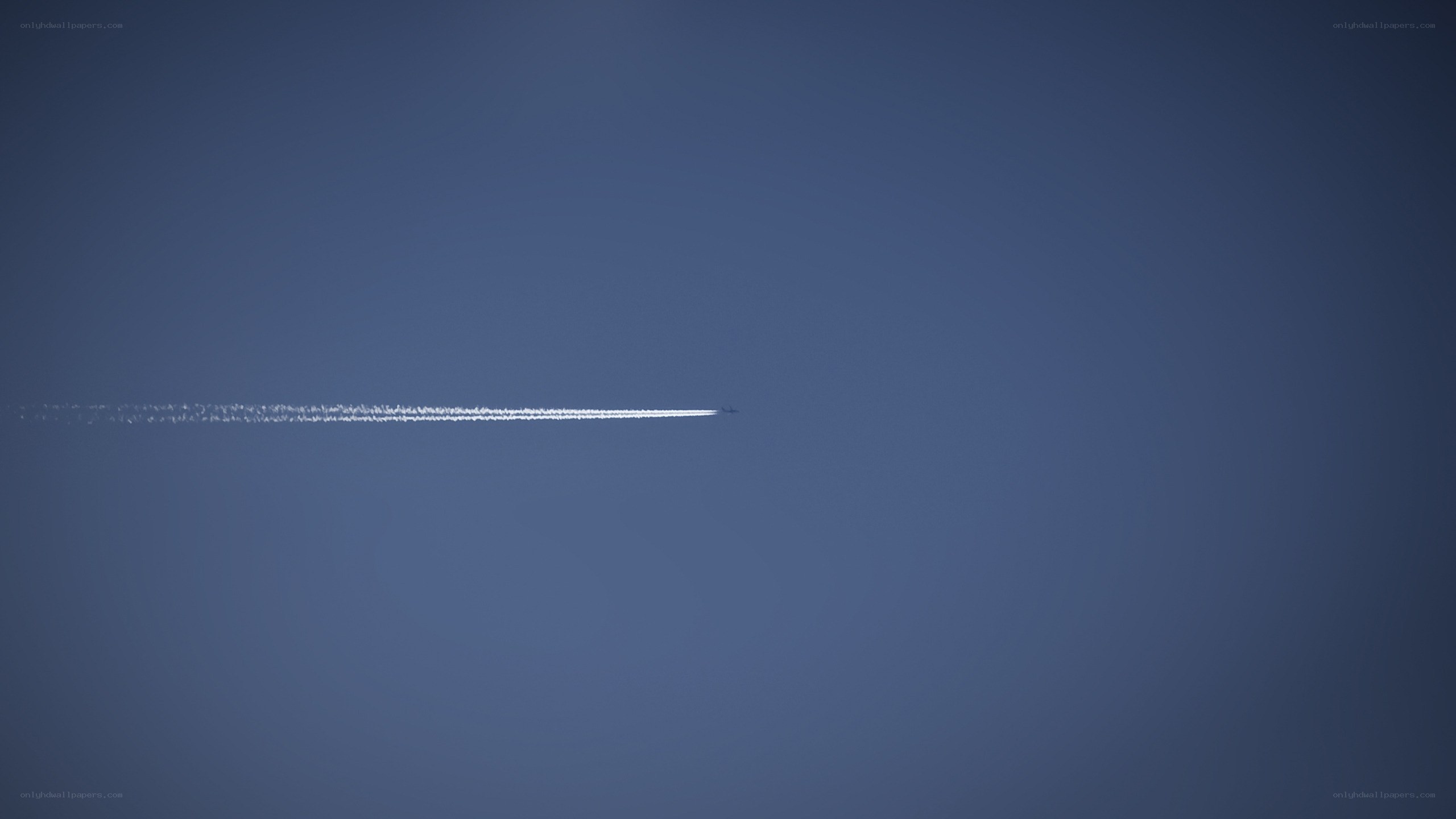 Airplane trail in blue sky