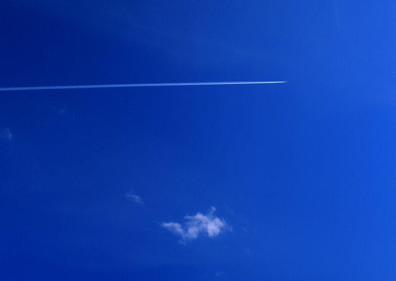 airplane trail in blue sky