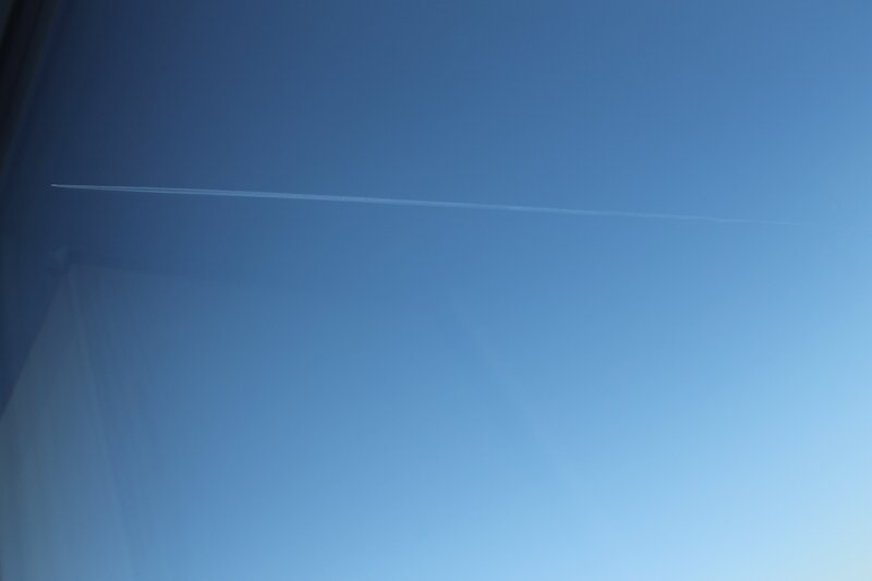 airplane trail in blue sky