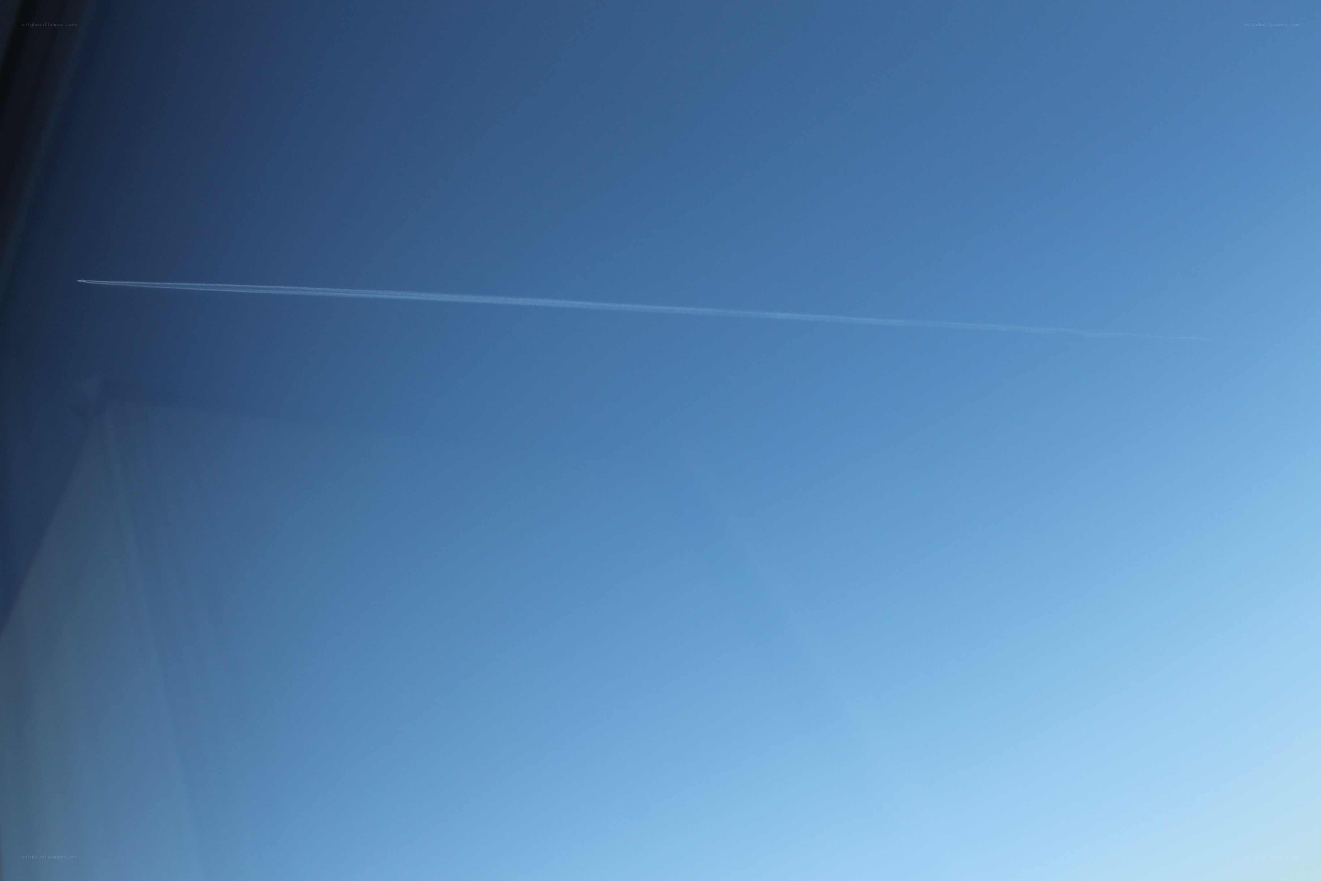 airplane trail in blue sky