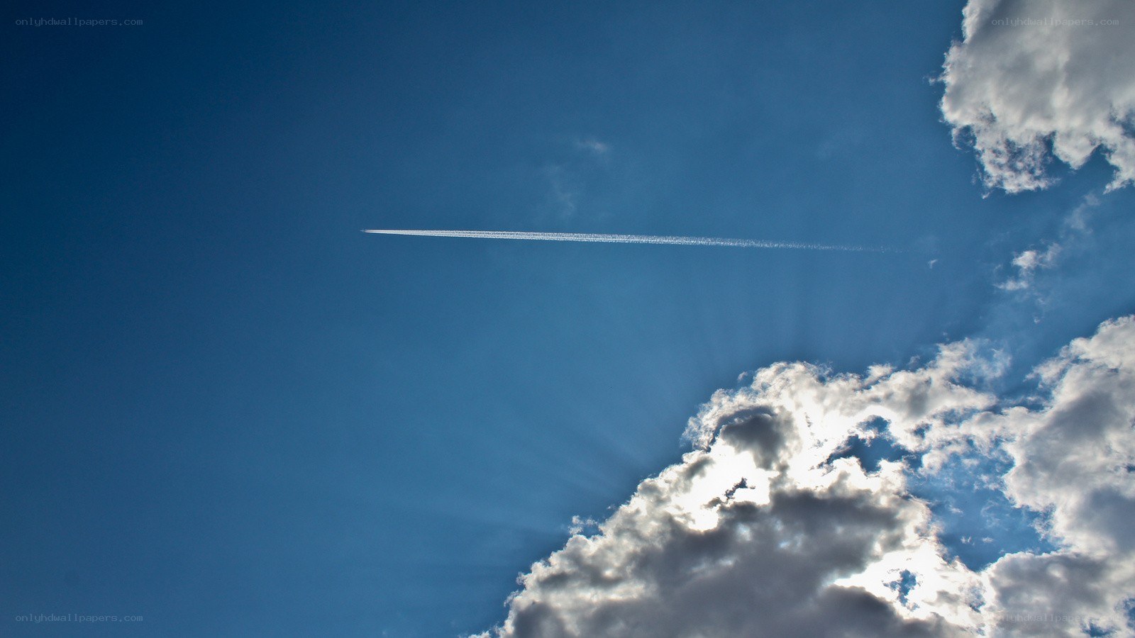 airplane trail in blue sky