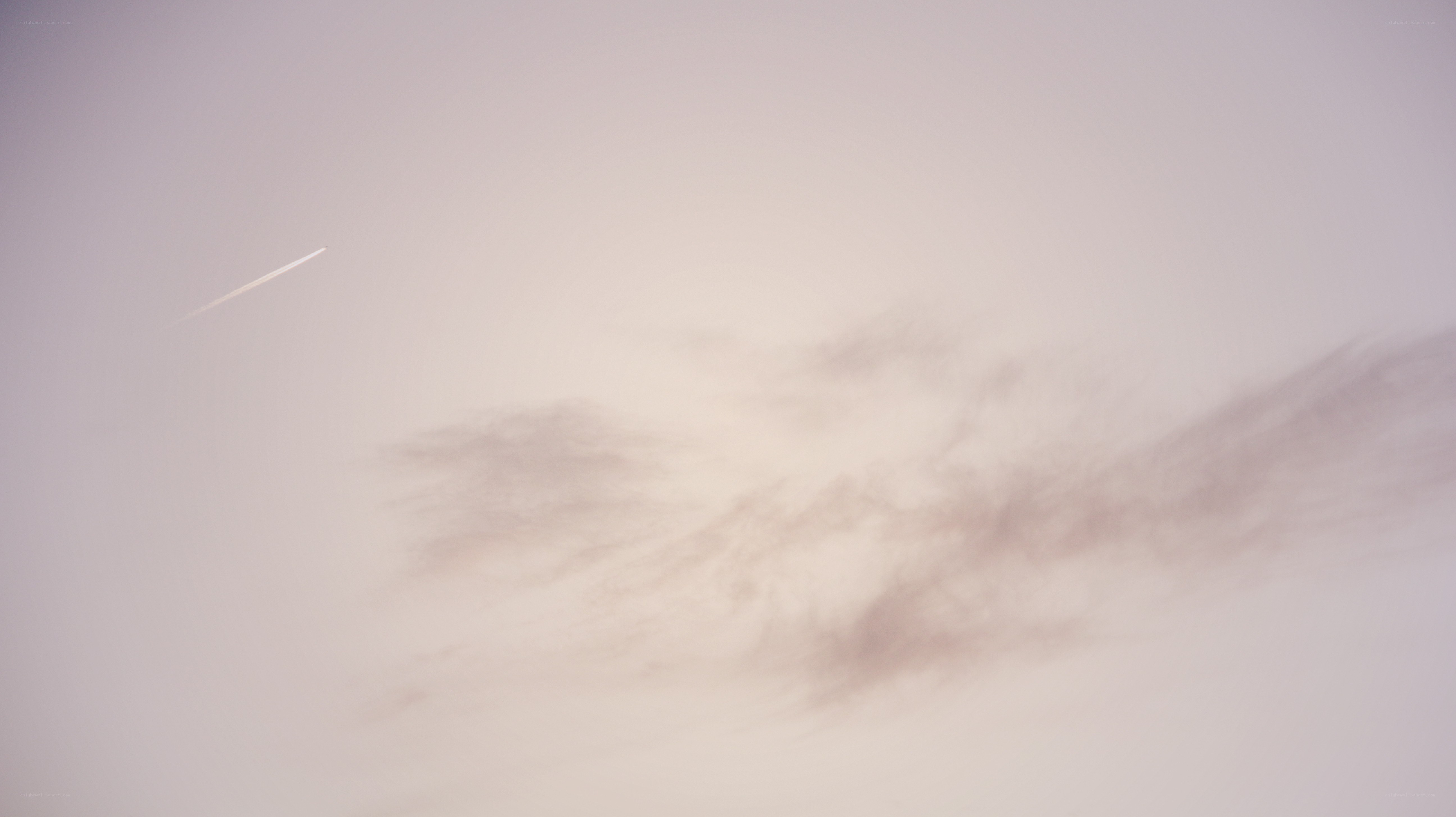 airplane trail in cloudy sky