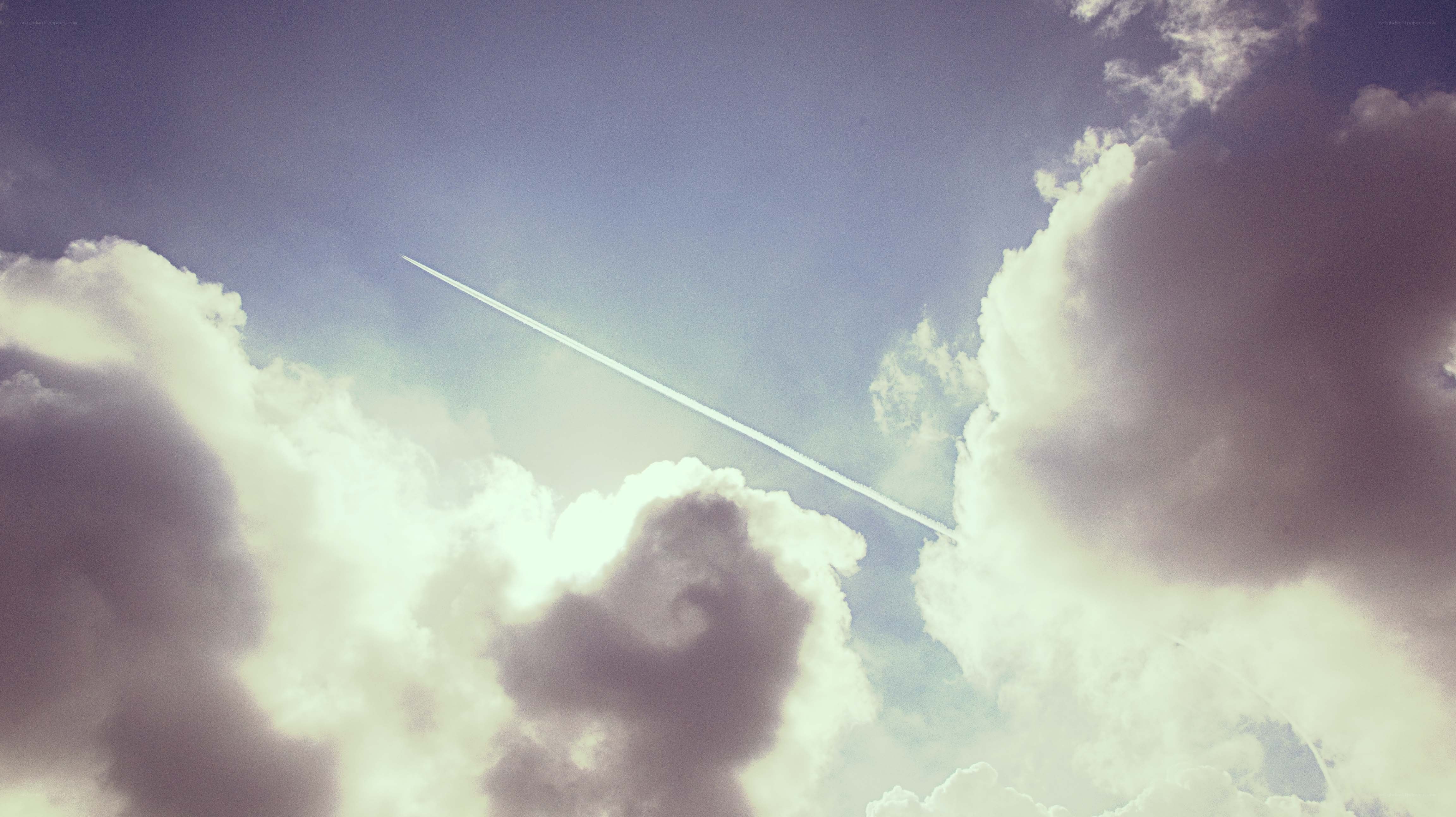 Airplane trail in cloudy sky