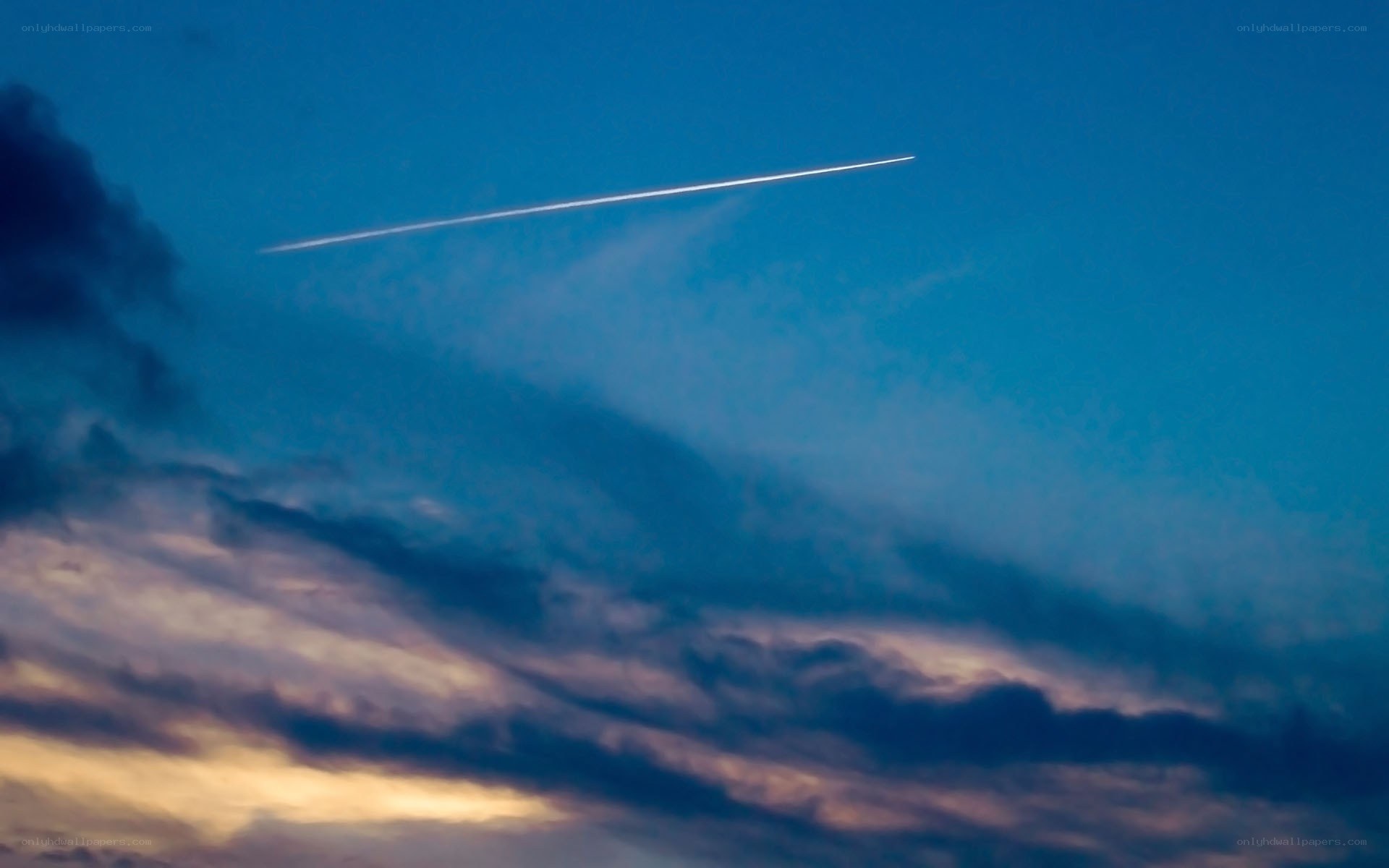 Airplane trail in twilight sky