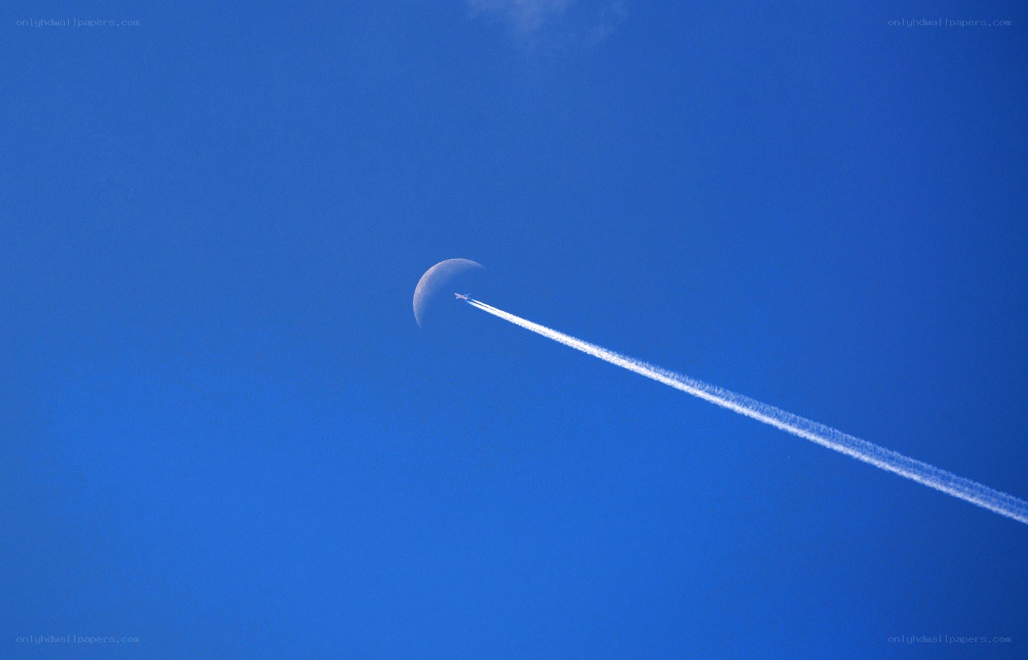 Airplane trail near moon
