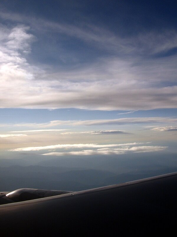 Airplane view of clouds and mountains