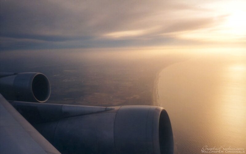 airplane view of coastline at sunset