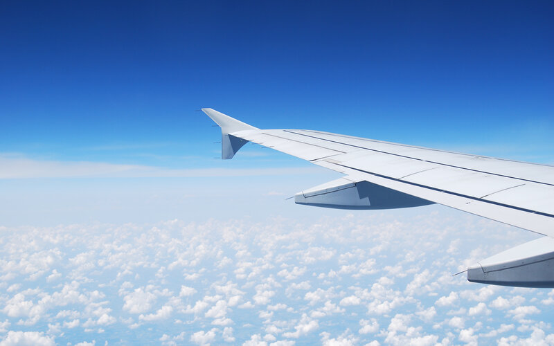 Airplane wing above clouds