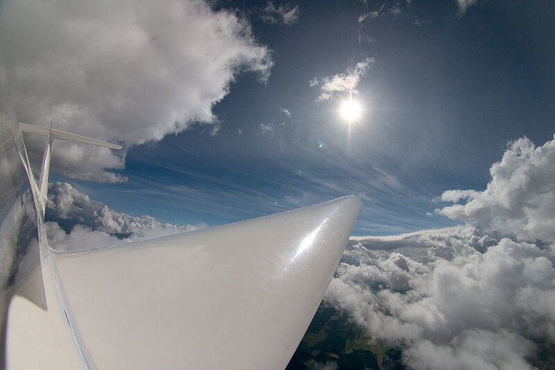 Airplane wing above clouds