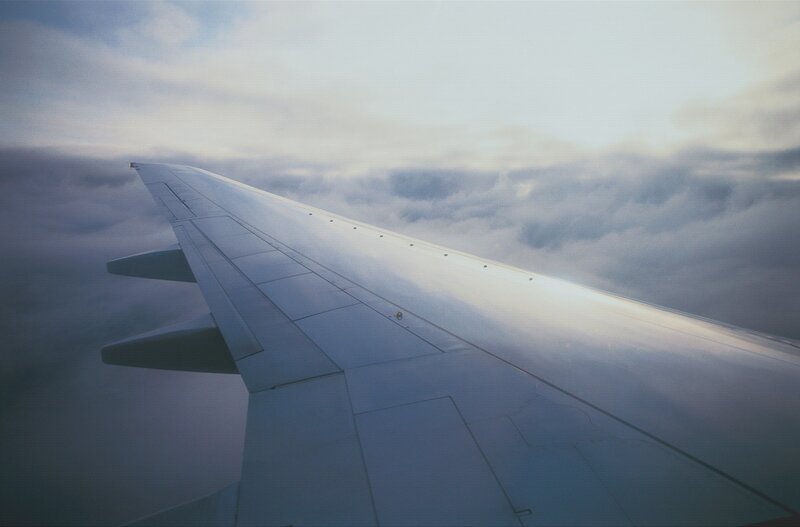 airplane wing above clouds