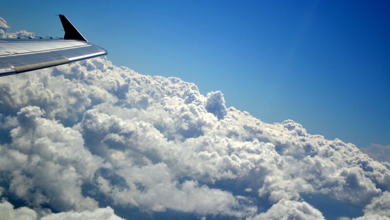 Airplane wing above clouds