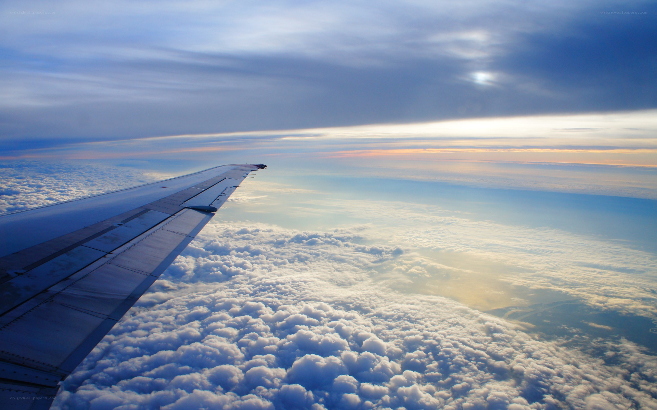 airplane wing above clouds