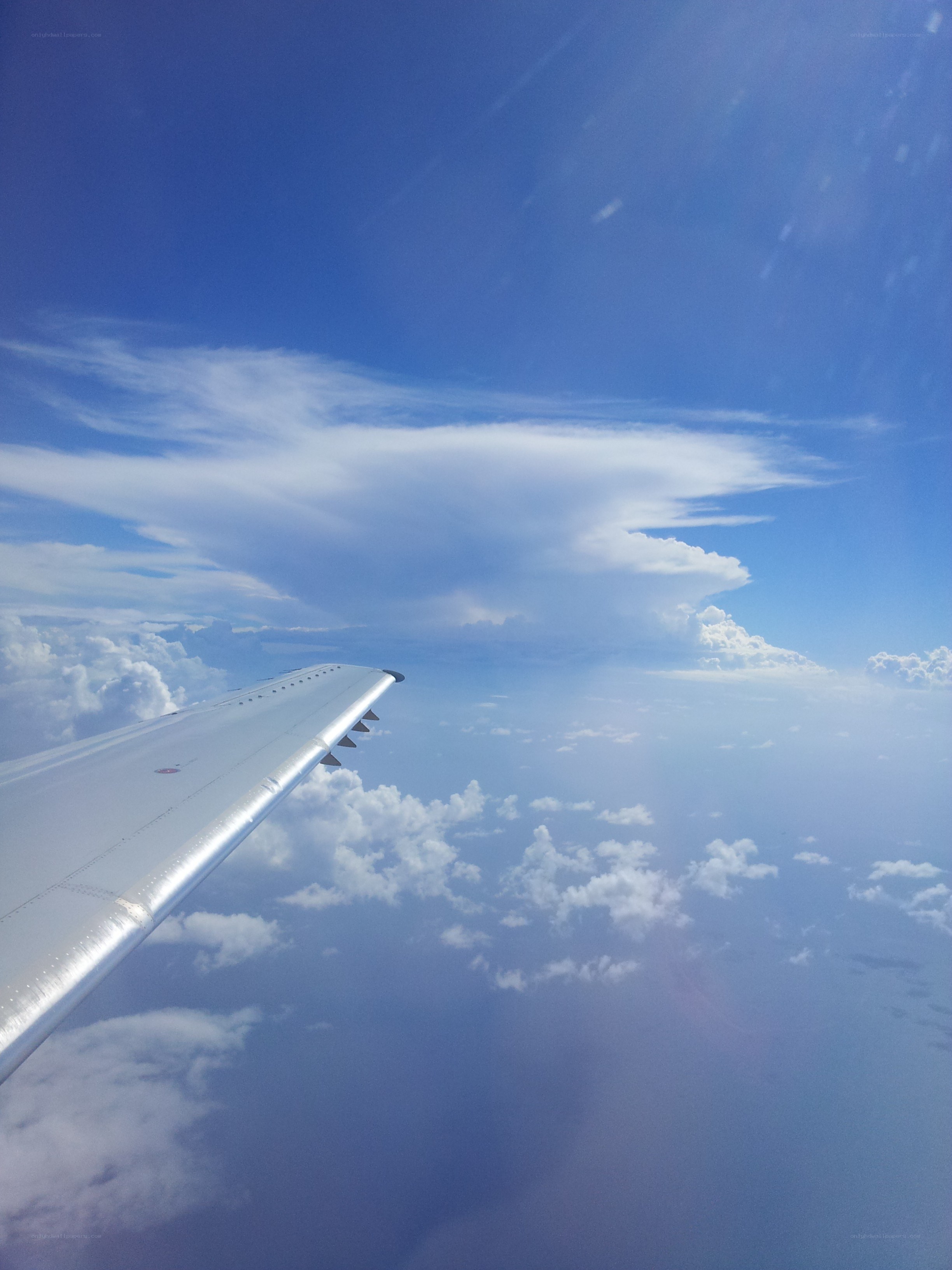Airplane wing above clouds
