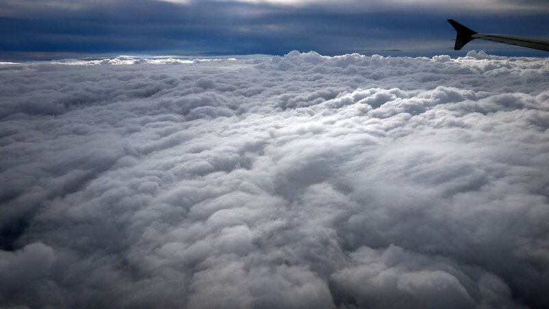 airplane wing above clouds
