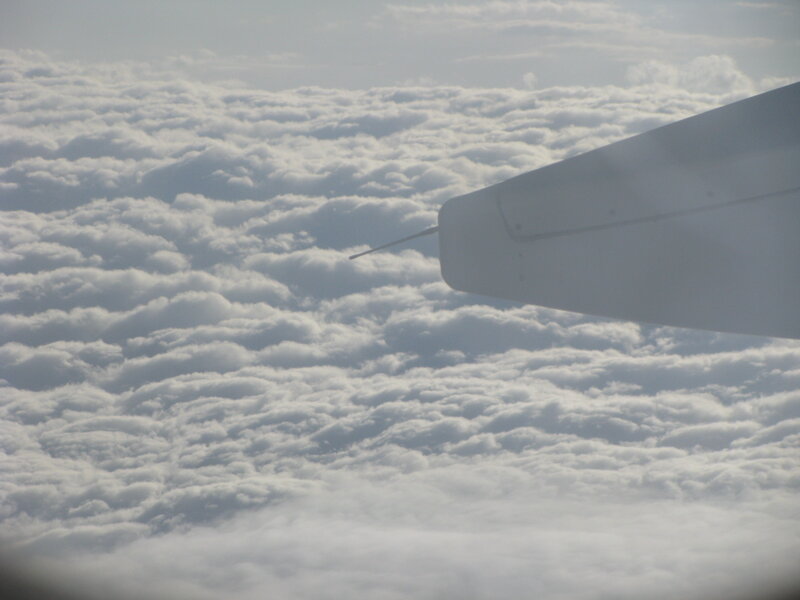 airplane wing above clouds