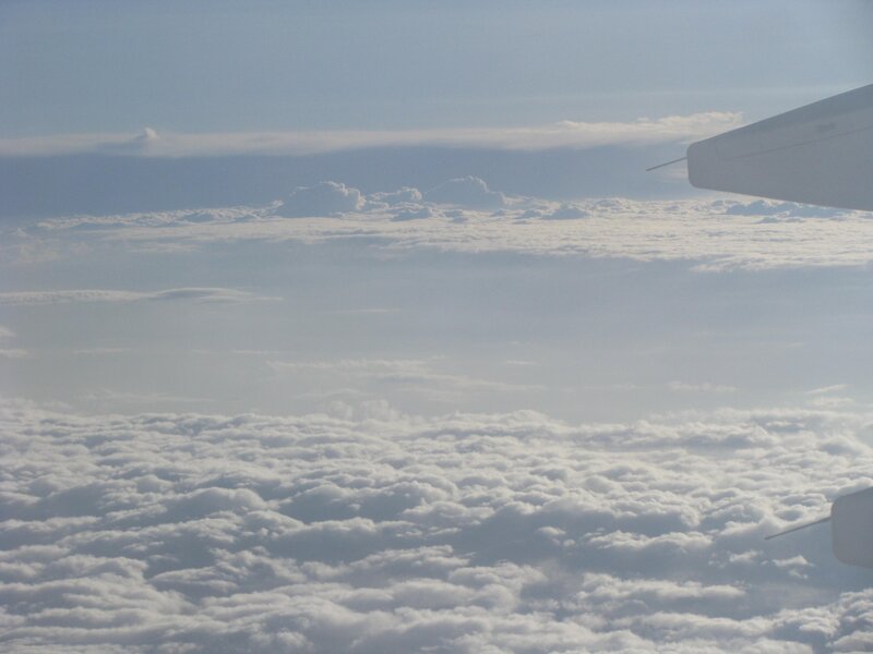 airplane wing above clouds