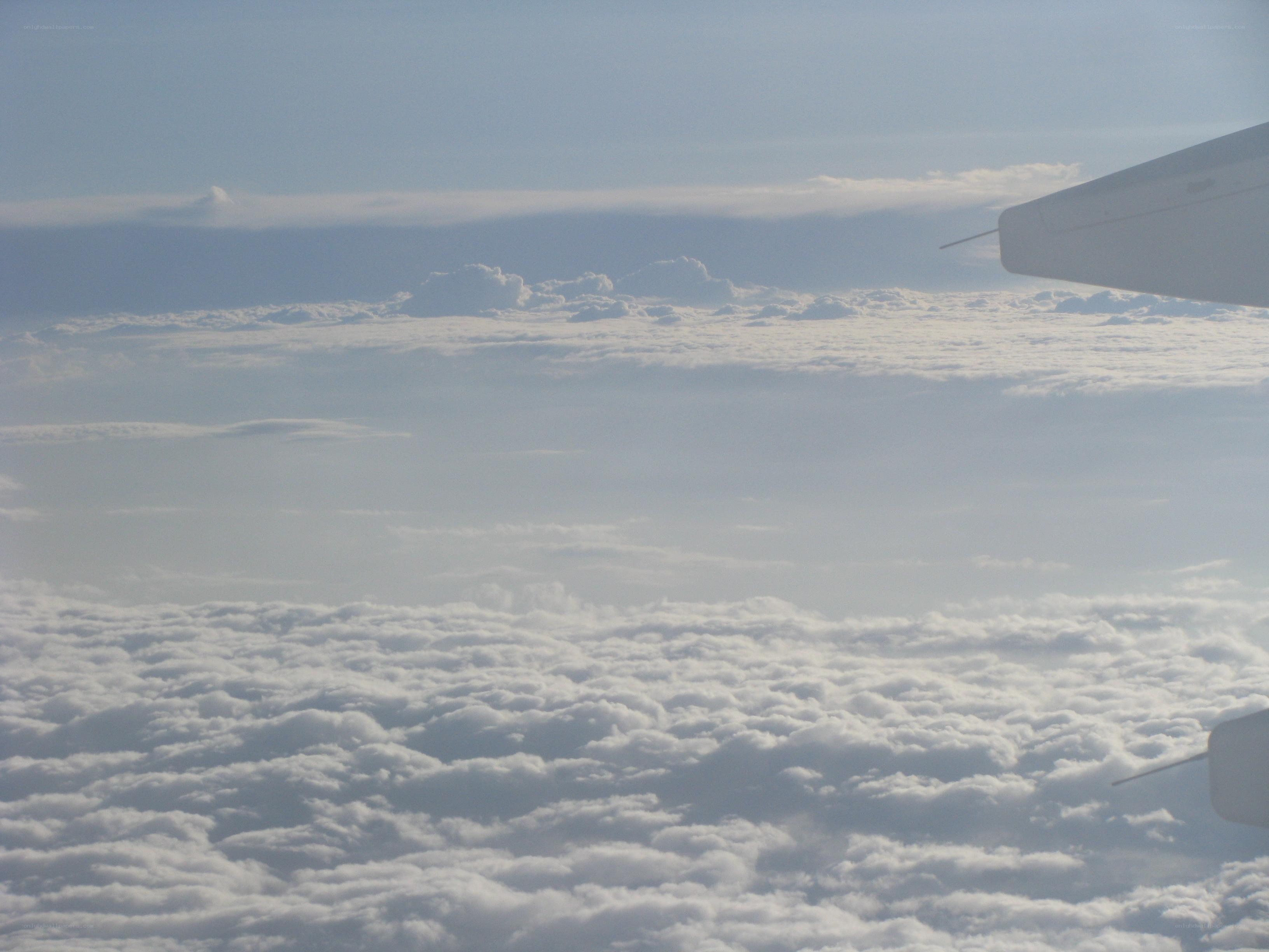 airplane wing above clouds