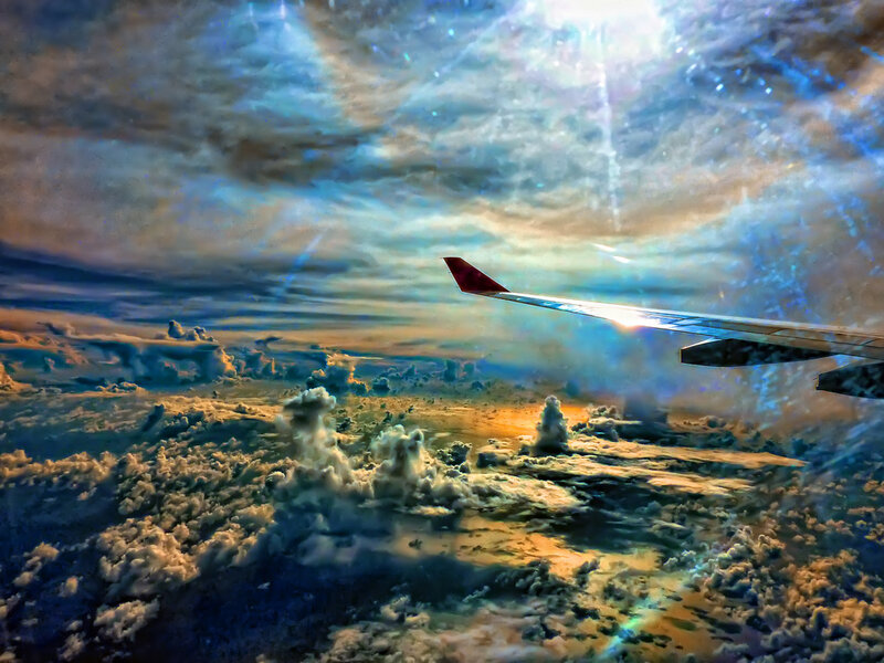 Airplane Wing Above Clouds — Blue, Dramatic