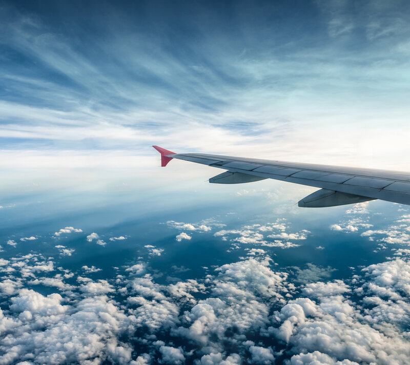 Airplane Wing Above Clouds — Blue, Serene, Afternoon, Photograph