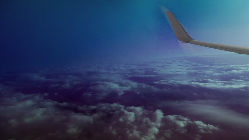 Airplane Wing Above Clouds — Blue, Serene, Night