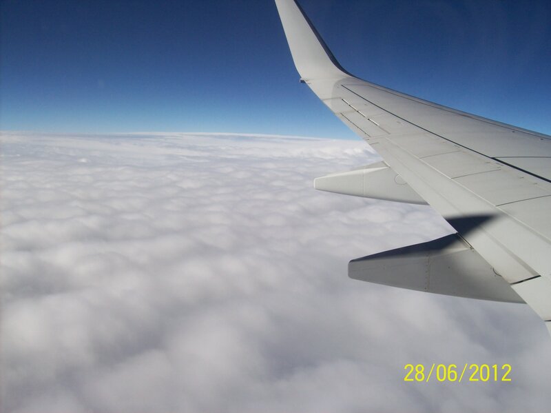 Airplane Wing Above Clouds — Blue, Serene, Photograph