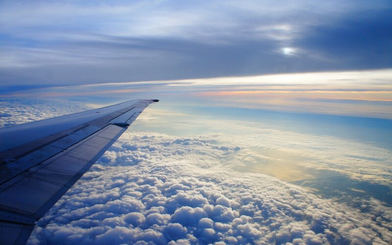 Airplane Wing Above Clouds — Blue, Serene, Sunset, Photograph