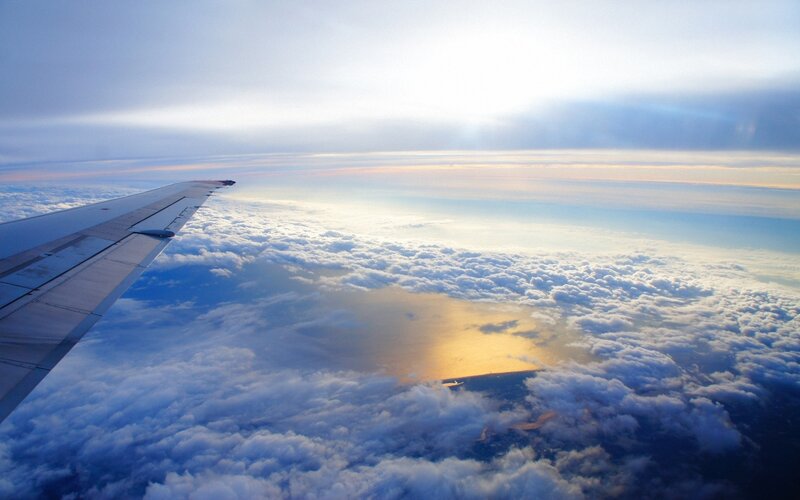Airplane Wing Above Clouds — Blue, Serene, Sunset